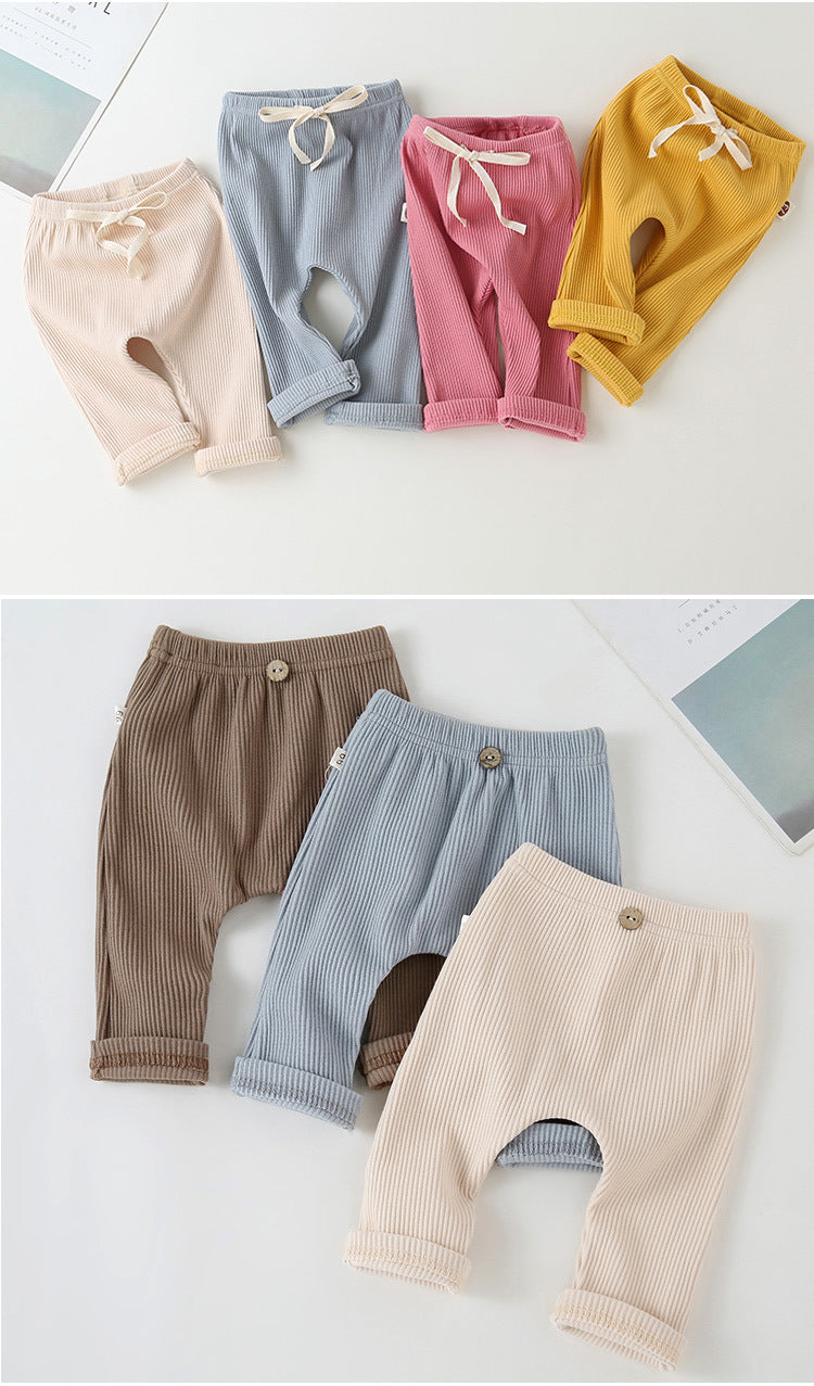 Ribbed baby leggings in assorted colors, featuring elastic drawstring waists or button accents and cuffed ankles.