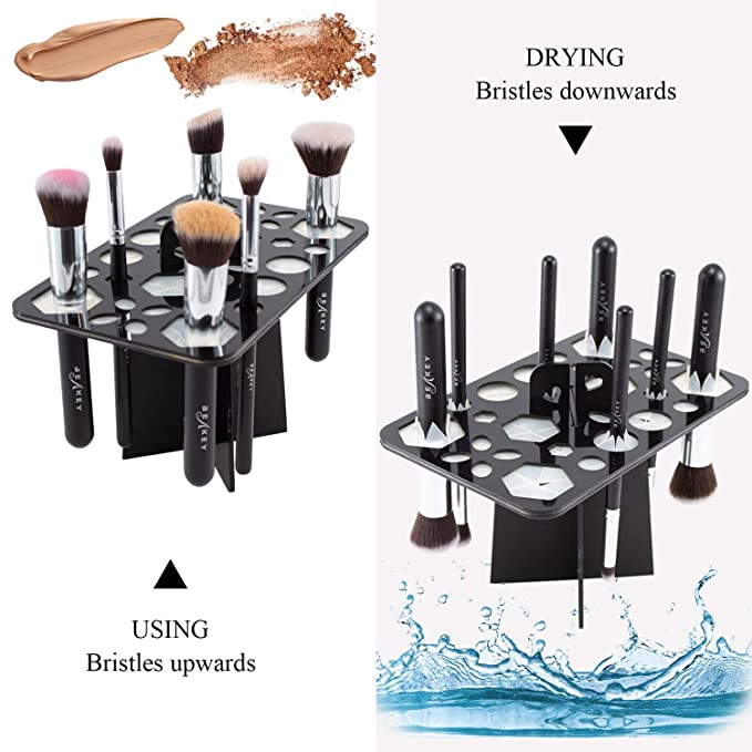 Black 14-hole acrylic makeup brush drying rack. Shows brushes stored with bristles facing up and hanging downwards.