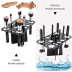 Black 14-hole acrylic makeup brush drying rack. Shows brushes stored with bristles facing up and hanging downwards.