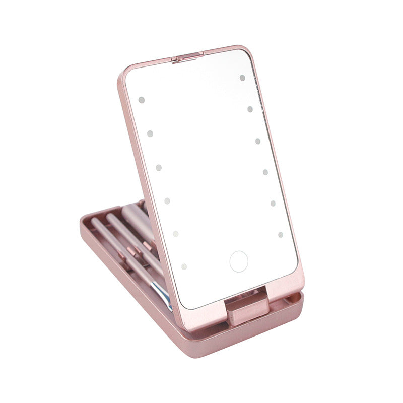 Rose gold folding makeup mirror with built-in LED lights and a matching set of makeup brushes inside the case.