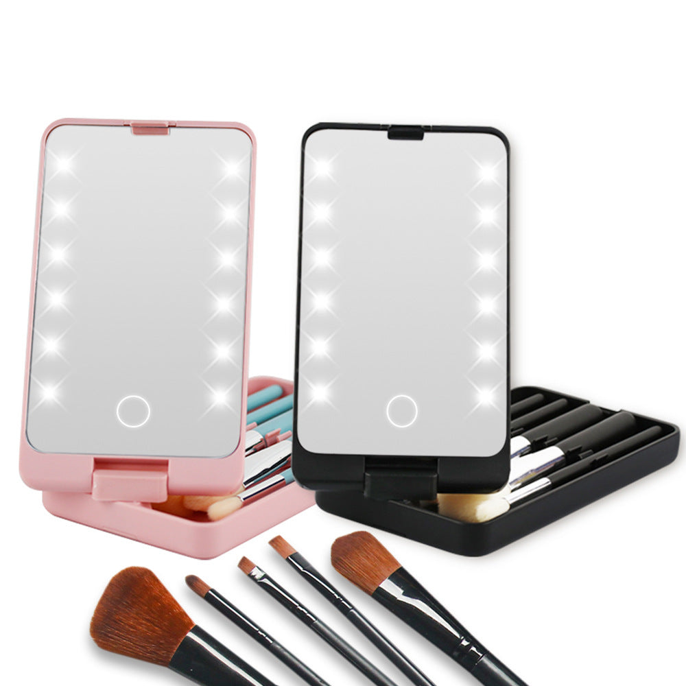 Pink and black folding LED makeup mirrors with integrated brush storage and a set of five makeup brushes.
