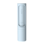 Light blue portable pet hair remover brush with self-cleaning mechanism and directional indicator text.