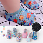 Baby's light blue mesh first-step shoes with colorful fish patterns and anti-slip black rubber soles.