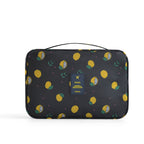 Black travel cosmetic bag with yellow lemon print, top handle, and a central blue "TRAVEL" tag.