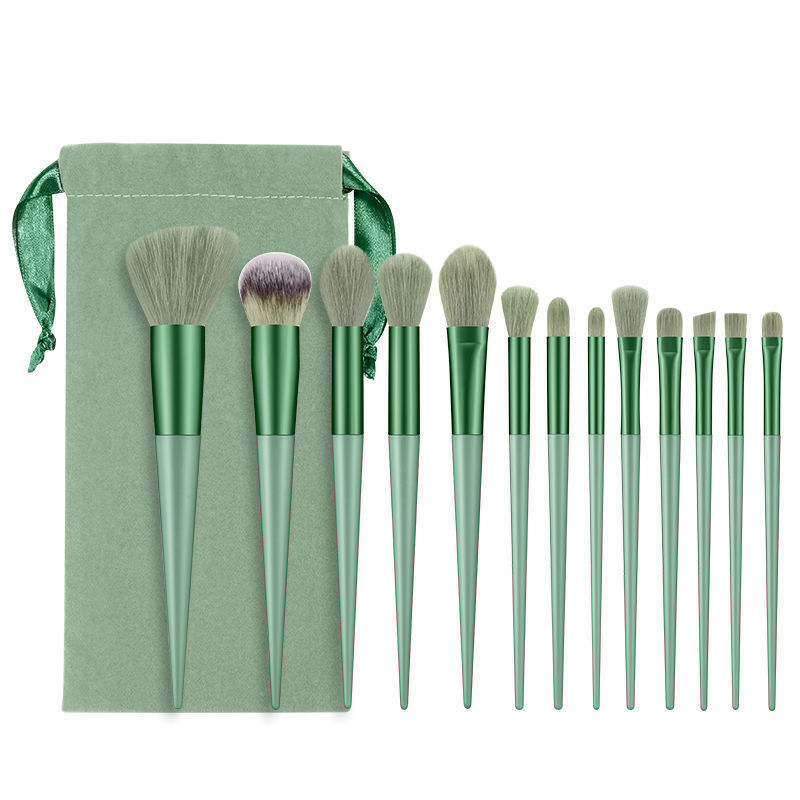 13-piece sage green makeup brush set with soft fiber bristles and matching velvet drawstring storage pouch.