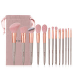 13-piece Banfi makeup brush set with soft pink bristles, rose gold ferrules, grey handles, and a pink velvet pouch.