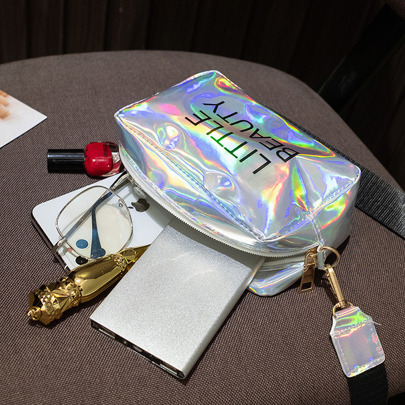 Holographic, waterproof cosmetic bag by Digitaldistribution375 featuring "LITTLE BEAUTY" text and a zipper pull.