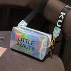 Holographic, waterproof cosmetic bag with "LITTLE BEAUTY" text, zipper closure, and black adjustable shoulder strap.