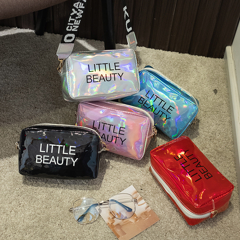 Five colorful, holographic "LITTLE BEAUTY" cosmetic bags in a variety of metallic waterproof finishes.