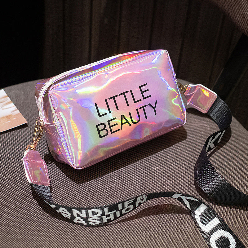 Holographic, waterproof cosmetic bag with "LITTLE BEAUTY" text, zipper closure, and black branded shoulder strap.