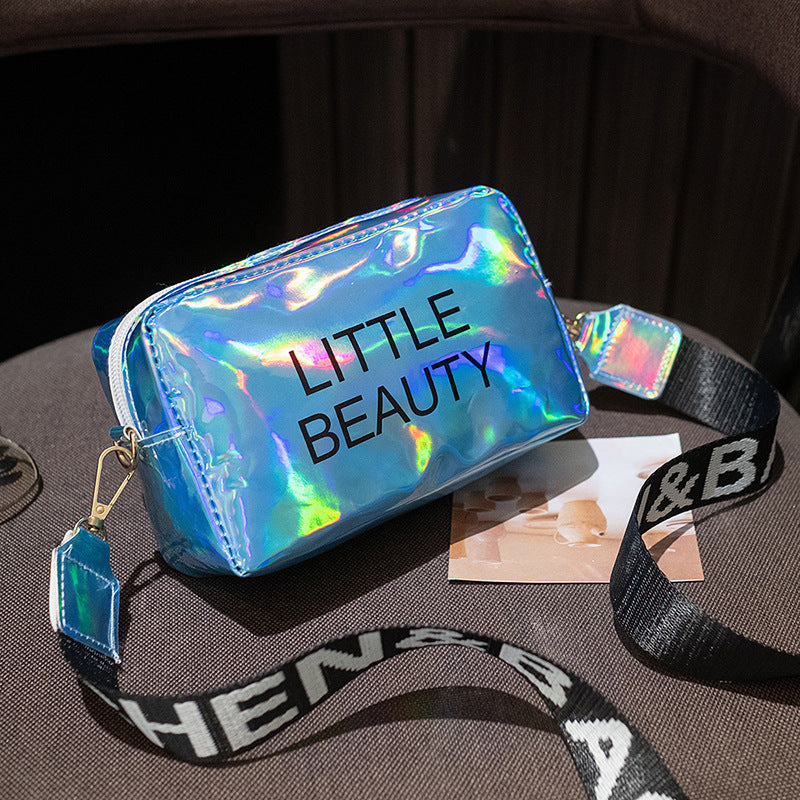 Holographic blue waterproof cosmetic bag with "LITTLE BEAUTY" text and a black branded shoulder strap.