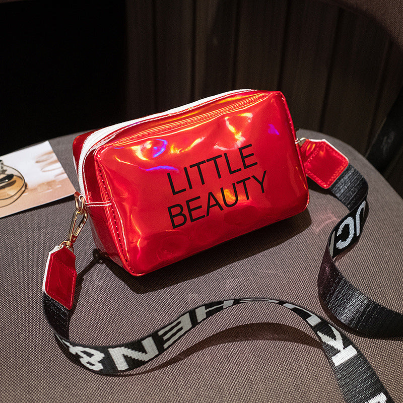Shiny red waterproof cosmetic bag with "LITTLE BEAUTY" text, a white zipper, and a black-and-white branded shoulder strap.