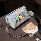 Waterproof, holographic "LITTLE BEAUTY" bag with a black logo-print strap on a dark surface.