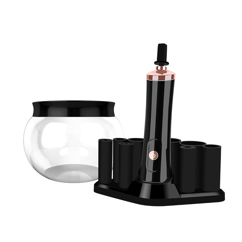 Black and rose gold electric makeup brush cleaner set with a glass bowl and brush holder stand.