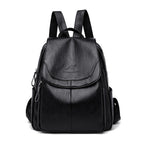 Black soft leather backpack with a flap closure, kangaroo logo, and adjustable straps. Stylish, casual, large capacity.