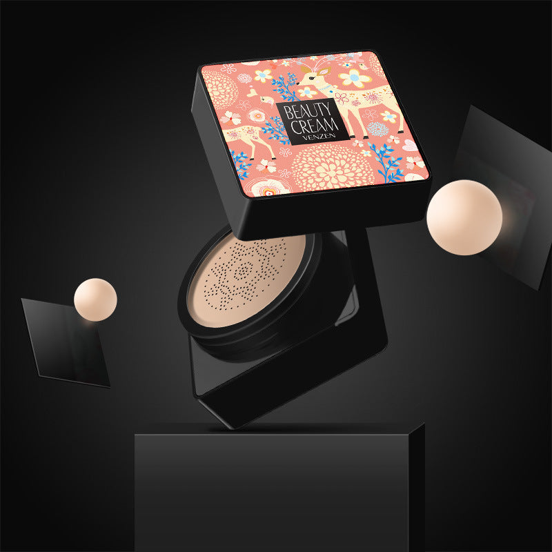 Open Venzen air cushion foundation with floral deer design lid, sponge base, and floating cosmetic balls on black.