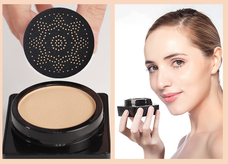 Black air cushion compact with beige BB cream and a mushroom-shaped applicator sponge; woman holding the product.