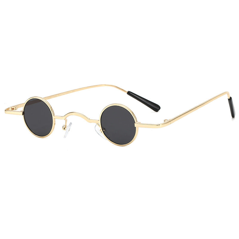 Retro sunglasses with small, circular black lenses and a thin gold metal frame, featuring black temple tips.