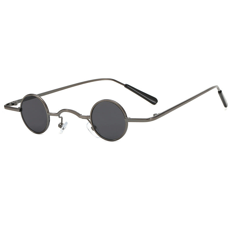 Retro-style unisex sunglasses featuring ultra-small, circular dark grey lenses and a slim, metallic gunmetal wire frame.