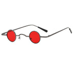 Retro unisex sunglasses with small, circular red lenses and a thin, metallic gunmetal grey frame.