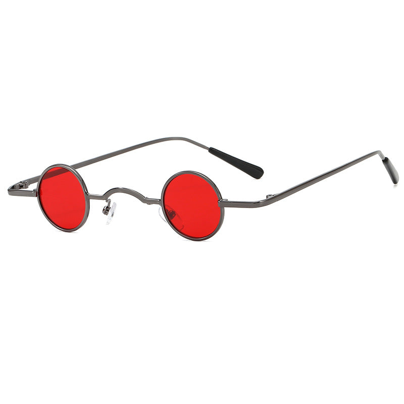 Retro unisex sunglasses with small, circular red lenses and a thin, metallic gunmetal grey frame.