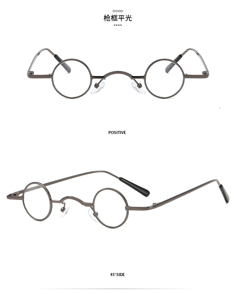 Small retro round glasses with thin gunmetal grey metal frames and clear lenses, shown from front and side angles.