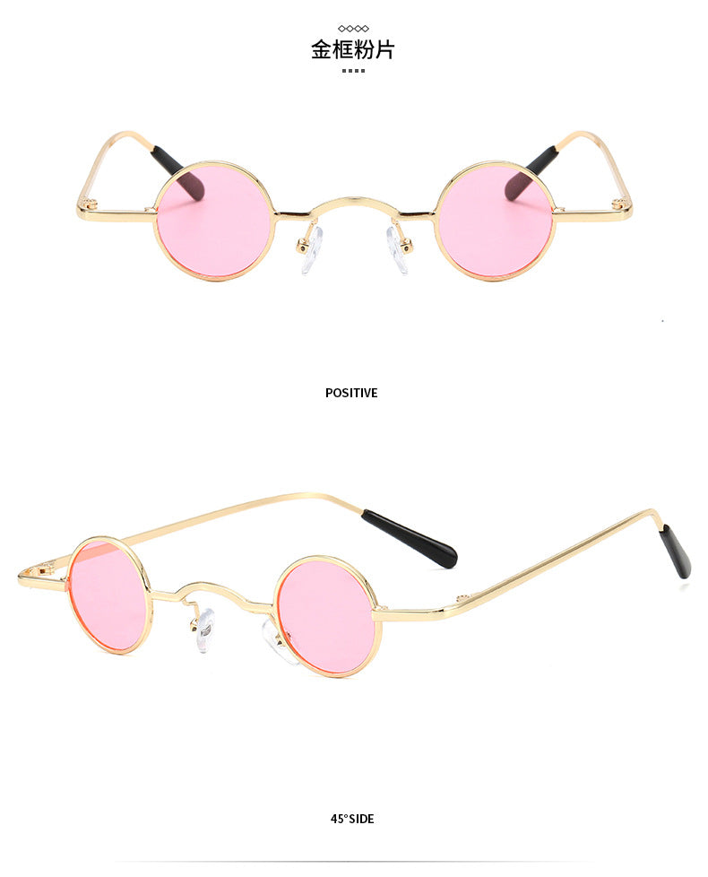 Retro-style sunglasses featuring small round pink lenses set in a thin gold metal frame with black temple tips.