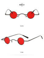 Small round retro sunglasses with dark metal frames, vibrant red lenses, and thin temples, shown front and side view.