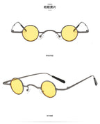 Retro round sunglasses with small, thin gunmetal grey metal frames and vibrant yellow lenses.