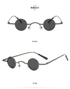 Small, round, retro metal-frame sunglasses in gunmetal grey with dark tinted lenses and adjustable nose pads.