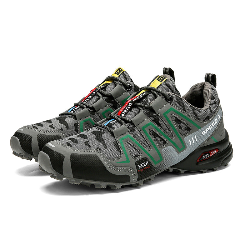 Grey camo men's tactical hiking shoes with green accents, black lugged soles, and "KEEP RUNNING" text detail.