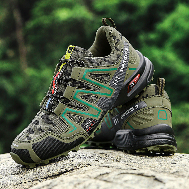 Olive green camo hiking sneakers with black accents, rugged tread soles, and "SPEED 3" branding on a rock background.
