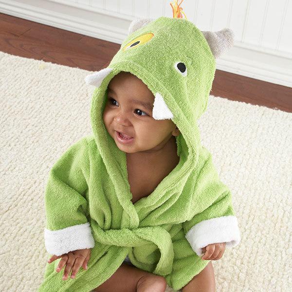A baby wears a green cotton hooded bathrobe featuring a playful monster face with horns and teeth.