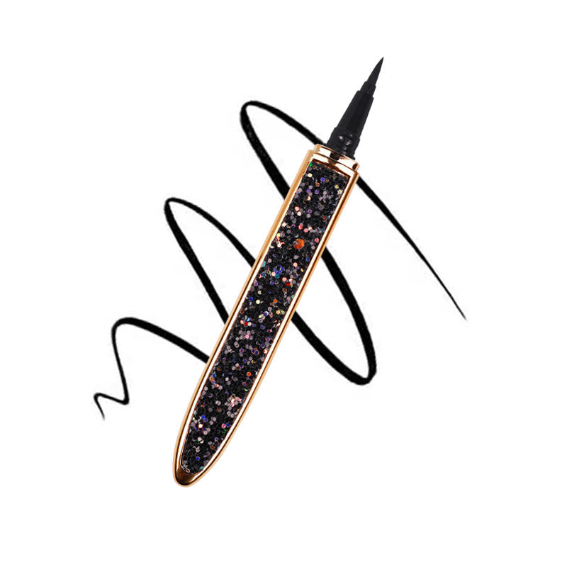 Magic Lashes black liquid eyeliner pen with gold trim and a sparkly, multi-colored glitter barrel.