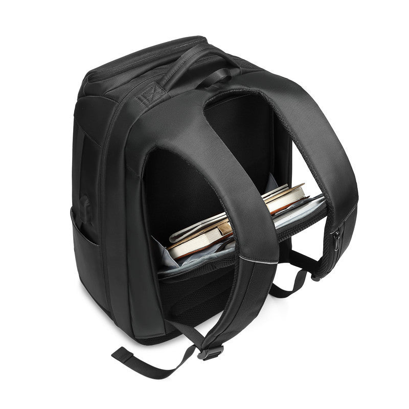 Black multifunctional backpack featuring a padded, open main compartment holding books against a white background.