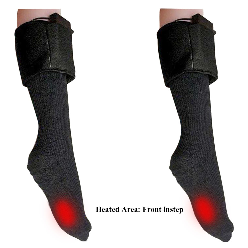 Pair of black electric heated socks with battery packs at the top and glowing red heat zones on the front insteps.