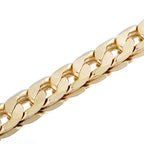 Close-up of a thick, polished gold-tone hip hop style tank chain necklace with interlocking links.