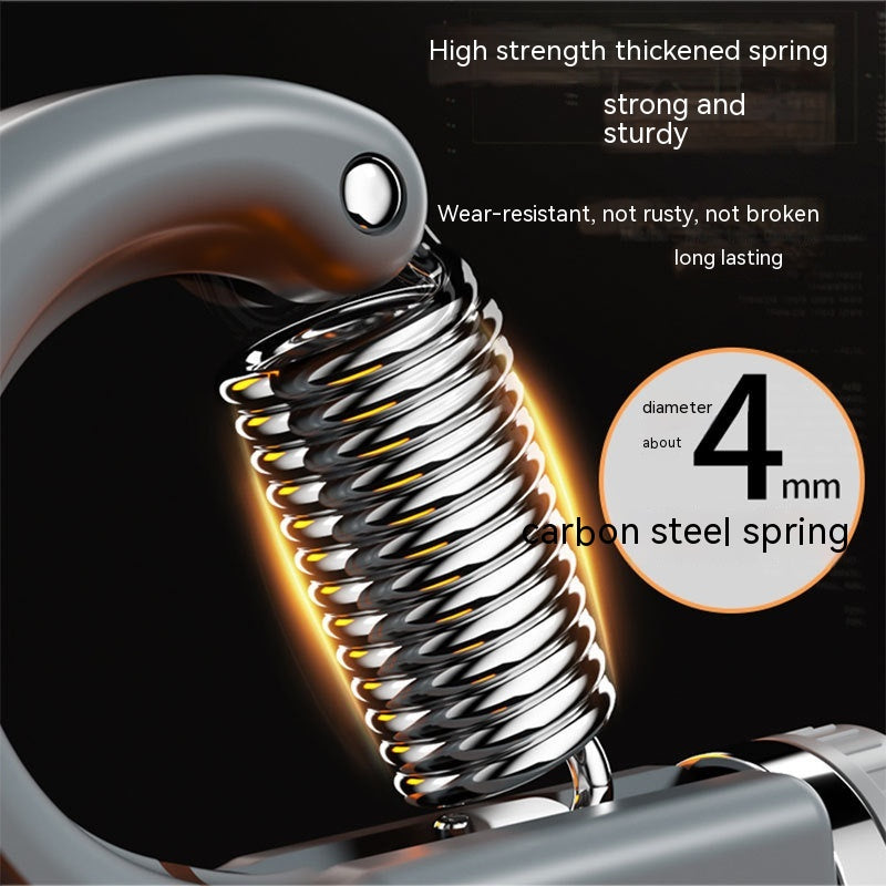 Close-up of a 4mm carbon steel spring on a grey, heavy-duty hand grip exerciser for strength training.