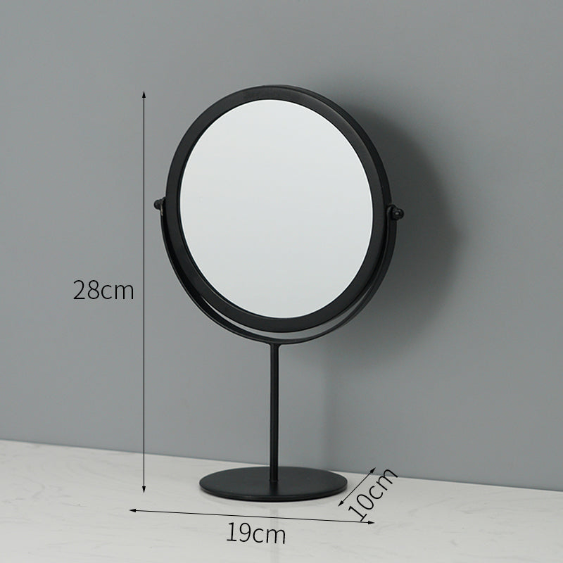 A round, black metal tabletop makeup mirror with a swivel design, measuring 28cm tall and 19cm wide.
