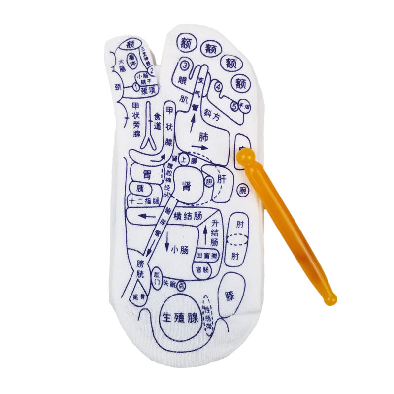 White reflexology acupressure socks with blue print charts and a yellow plastic massage tool on a white background.