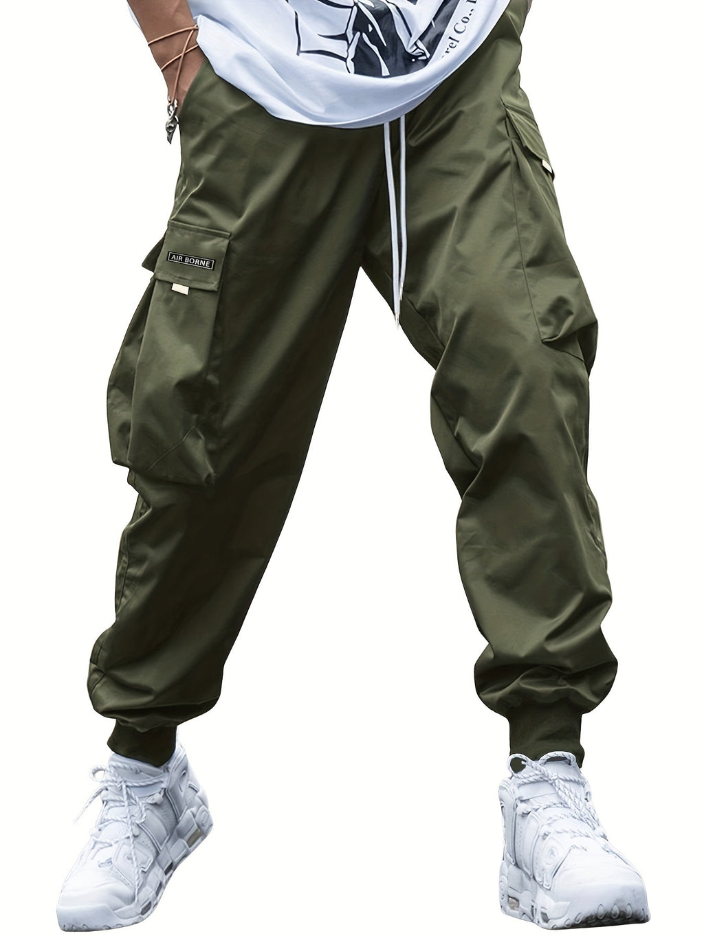 Olive green men's cargo joggers with a drawstring waist, large side pockets, and cuffed ankles on a white background.