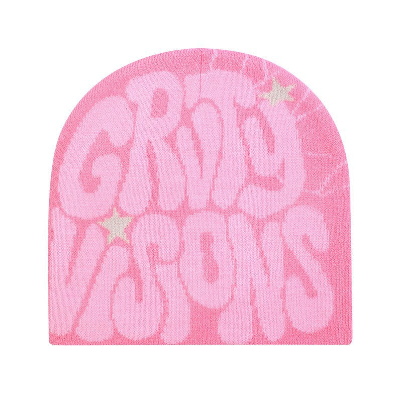 Pink knit hip hop beanie with bubble-letter "GRIT VISIONS" text and small star accents.