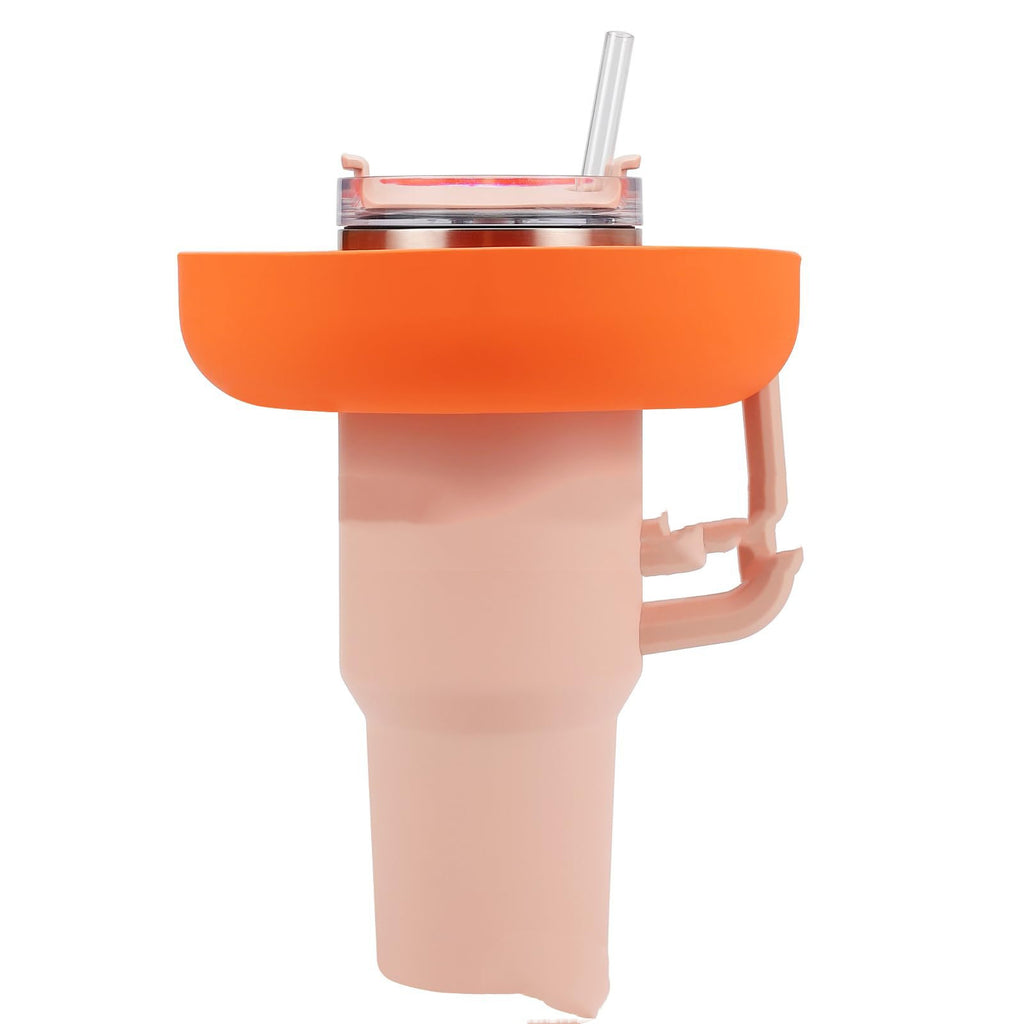 Orange 4-compartment silicone snack tray attached to a light pink 40oz tumbler with a clear straw.