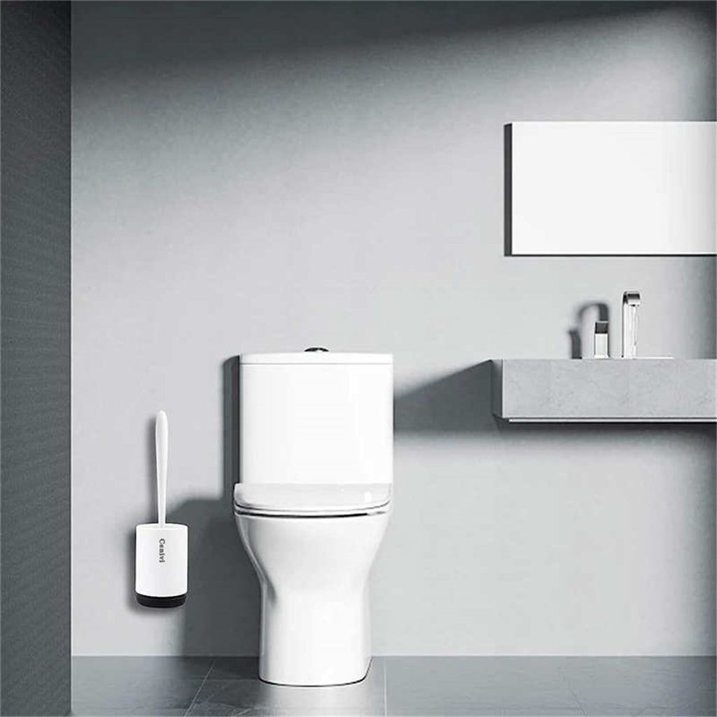 White toilet brush set with a slim handle and wall-mounted base in a modern, minimalist bathroom setting.