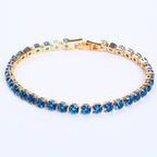 Gold-tone tennis bracelet featuring micro-inlaid round blue zircon stones in a classic hip-hop link setting.