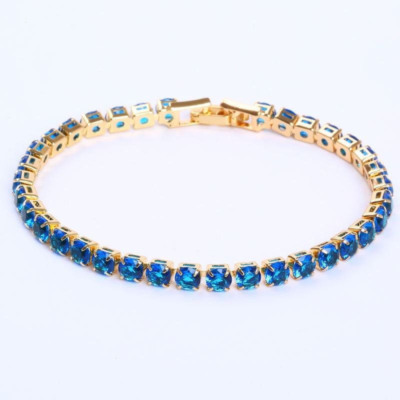 Gold-tone tennis bracelet featuring micro-inlaid round blue zircon stones in a classic hip-hop link setting.