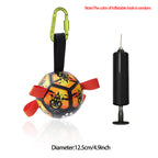 Orange and black Halloween-themed dog soccer ball with nylon grab tabs, green carabiner, and an included air pump.
