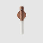 Walnut wood magnetic LED night light with a motion sensor and frosted white light diffuser on a plain background.