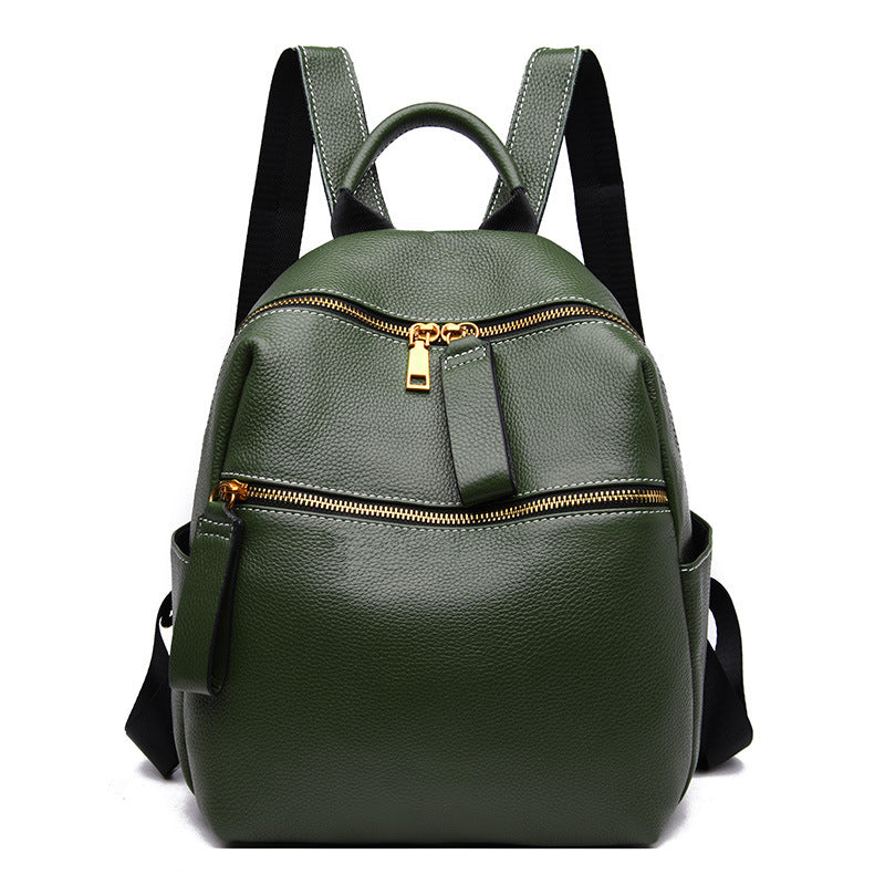 Small olive green top-grain leather backpack with two gold-zippered front pockets and black adjustable straps.