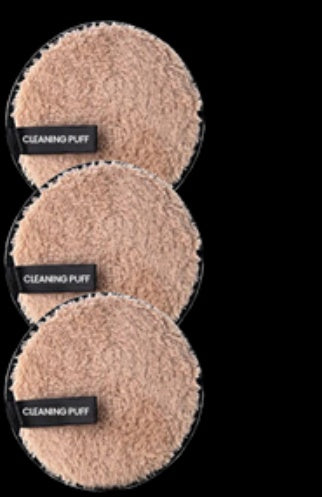 Three round, beige microfiber makeup remover puffs stacked vertically, each with a black "CLEANING PUFF" tab.